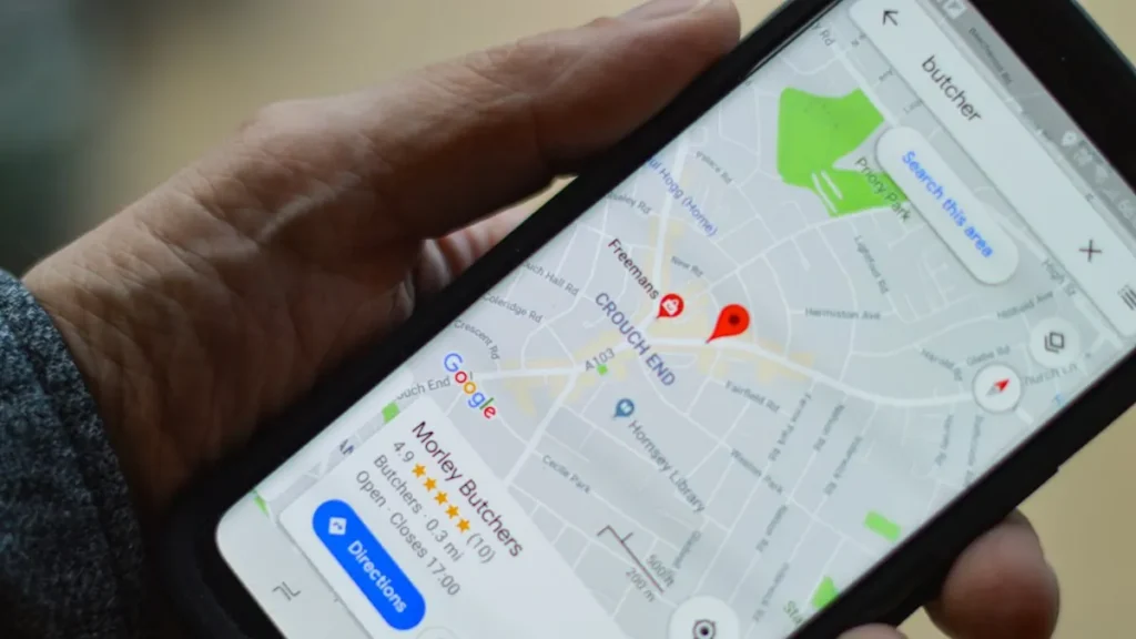 Hand holding a phone showing Google Maps